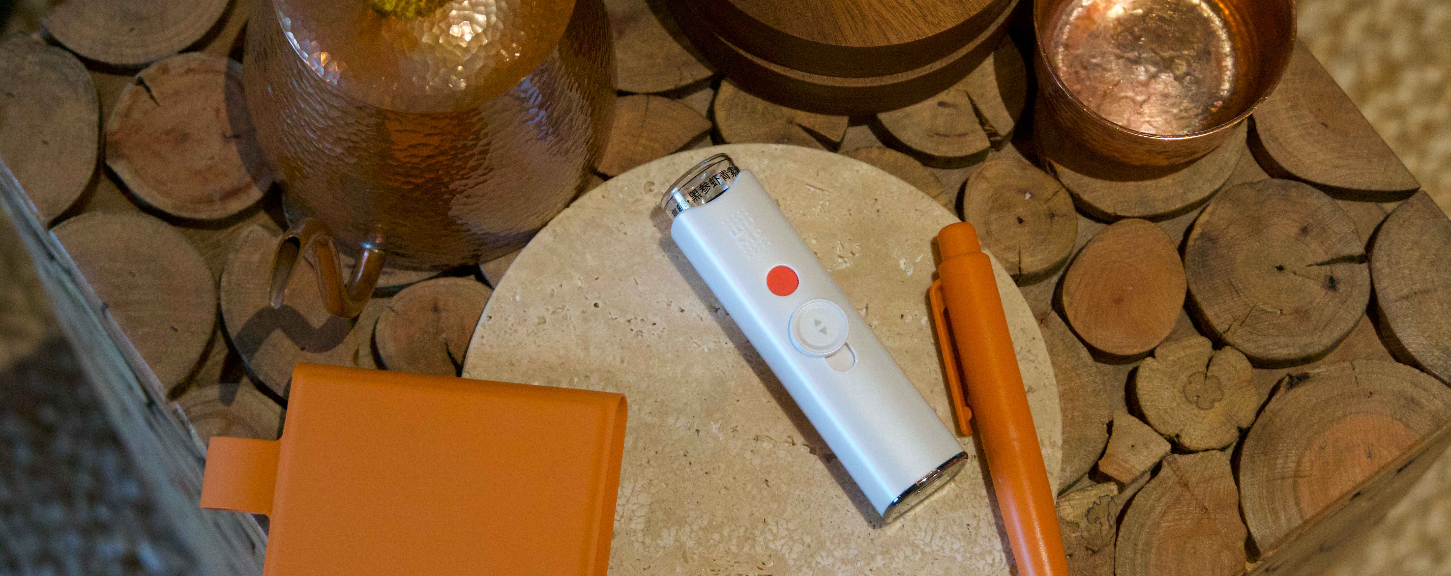 A-person-using-the-sleek-Wumo-Electronic-Eye-Spray-in-a-modern-office-setting.